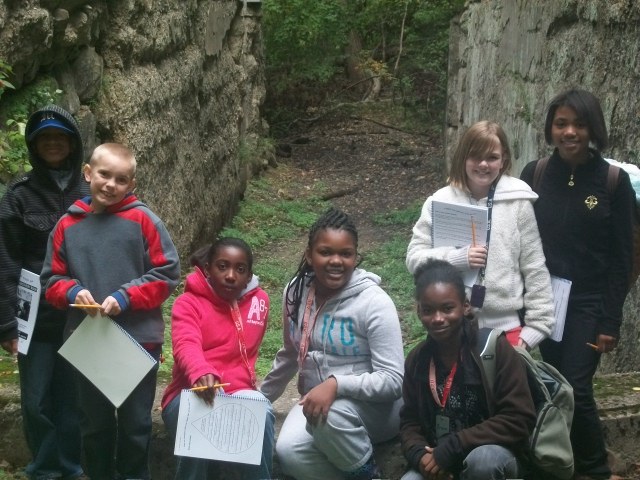 Exploring the old canal locks is part of the class Journey to the River.  These students from Portage Path pause for a photo after filling in answers in their discovery books.